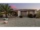 Backyard with a covered patio, low maintenance gravel landscaping, offering privacy and tranquility at 19975 N Crescent Way, Surprise, AZ 85374