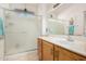 Bathroom with a frosted glass enclosed shower, bright lights and wood cabinets at 19975 N Crescent Way, Surprise, AZ 85374