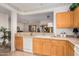 Spacious kitchen with light wood cabinetry and a view to an adjacent living area at 19975 N Crescent Way, Surprise, AZ 85374