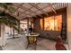 Charming covered patio with a dining set, grill, and views of the well-maintained backyard at 19975 N Crescent Way, Surprise, AZ 85374