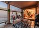 Relaxing covered patio with comfortable seating, a stylish rug, and seamless access to the indoor living space at 19975 N Crescent Way, Surprise, AZ 85374