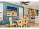 Colorful dining area with backyard views, custom window shutters and bar seating in adjacent kitchen at 20139 N Rawhide Way, Surprise, AZ 85387