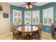 Cozy dining area with natural light, a ceiling fan, and charming wood furniture at 20139 N Rawhide Way, Surprise, AZ 85387