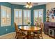 Bright dining area with backyard views from multiple windows and a decorative ceiling fan at 20139 N Rawhide Way, Surprise, AZ 85387