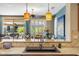 Kitchen bar top with stainless steel sink, modern fixtures, and view of outdoor entertaining space at 20139 N Rawhide Way, Surprise, AZ 85387