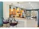 Kitchen featuring wood cabinetry, pendant lighting, stainless steel appliances, and barstool seating at 20139 N Rawhide Way, Surprise, AZ 85387