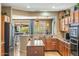 Well-lit kitchen featuring an island, stainless steel appliances, and convenient access to the patio at 20139 N Rawhide Way, Surprise, AZ 85387