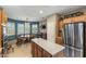 Kitchen featuring stainless steel appliances, wood cabinetry, tile floors, and breakfast nook at 20139 N Rawhide Way, Surprise, AZ 85387