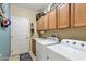 Laundry room with washer, dryer, sink, and ample cabinet storage at 20139 N Rawhide Way, Surprise, AZ 85387