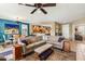 Open-concept living room with plush seating, dining area, and a view into the kitchen at 20139 N Rawhide Way, Surprise, AZ 85387