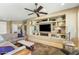 Cozy living room with a custom entertainment center, tile floors, and comfortable seating at 20139 N Rawhide Way, Surprise, AZ 85387