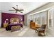 Spacious bedroom with purple accent wall, natural light, and a decorative ceiling fan at 20139 N Rawhide Way, Surprise, AZ 85387