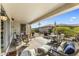 Covered patio featuring comfortable seating and a view of the landscaped backyard at 20139 N Rawhide Way, Surprise, AZ 85387