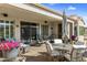 Covered patio with outdoor seating, landscaping, and a view of the backyard at 20139 N Rawhide Way, Surprise, AZ 85387