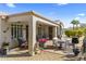 Relaxing covered patio with dining area and a view of desert landscaping at 20139 N Rawhide Way, Surprise, AZ 85387