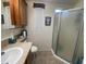 Bathroom with shower, cabinet, window, and fixtures at 2070 W Klamath Ave, Apache Junction, AZ 85119