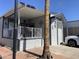 Charming home exterior featuring a cozy porch, tidy landscaping, and a well-maintained yard, adding to its appeal at 2070 W Klamath Ave, Apache Junction, AZ 85119