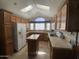 Open kitchen with an island, light-colored cabinets and countertops, and modern appliances at 2070 W Klamath Ave, Apache Junction, AZ 85119
