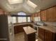 Bright kitchen with a kitchen island, light colored cabinets, appliances and beige colored counter tops at 2070 W Klamath Ave, Apache Junction, AZ 85119