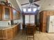 Well-lit kitchen offering custom wood cabinets, a comfortable dining area, and ample storage at 2070 W Klamath Ave, Apache Junction, AZ 85119
