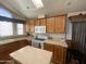 Kitchen featuring light-colored cabinets, countertops, appliances, and a kitchen island at 2070 W Klamath Ave, Apache Junction, AZ 85119