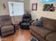Cozy living room with a comfortable seating arrangement and hardwood floors at 2070 W Klamath Ave, Apache Junction, AZ 85119