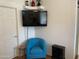 Stylish living room featuring a modern blue chair, decorative art, and a mounted TV at 2070 W Klamath Ave, Apache Junction, AZ 85119