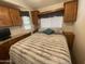 Bedroom with cabinets, window, and comfortable bed at 2070 W Klamath Ave, Apache Junction, AZ 85119