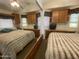 Bedroom with mirrored wall, cabinets and large bed at 2070 W Klamath Ave, Apache Junction, AZ 85119