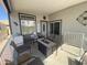 Relaxing covered porch with comfortable seating, a fire pit table, and stylish decor, perfect for outdoor lounging at 2070 W Klamath Ave, Apache Junction, AZ 85119