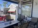 Inviting porch with a fire pit table, seating, and a view of palm trees; ideal for outdoor entertaining at 2070 W Klamath Ave, Apache Junction, AZ 85119