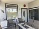 Charming porch featuring comfortable seating, a fire pit table, and tasteful decor, creating a welcoming outdoor space at 2070 W Klamath Ave, Apache Junction, AZ 85119