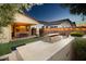 Inviting outdoor kitchen and covered patio with string lights, perfect for evening entertaining at 20906 E Macaw Dr, Queen Creek, AZ 85142