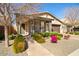 Charming home exterior with a covered porch, landscaped yard, and brick walkway on a sunny day at 20906 E Macaw Dr, Queen Creek, AZ 85142