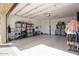 Spacious garage with ample storage, shelving units, and a clean, epoxy-coated floor at 20906 E Macaw Dr, Queen Creek, AZ 85142