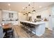 Open kitchen featuring stainless appliances, a large white island and views to the dining area at 20906 E Macaw Dr, Queen Creek, AZ 85142
