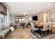 Open-concept living and dining area with wood floors, a large TV, and a neutral color palette at 20906 E Macaw Dr, Queen Creek, AZ 85142