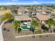 Expansive aerial showing a home with a private pool, covered patio, and desert landscaping in a residential neighborhood at 21141 E Stirrup St, Queen Creek, AZ 85142