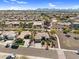 Expansive aerial shot of a neighborhood showcasing desert landscaping and mountain views at 21141 E Stirrup St, Queen Creek, AZ 85142