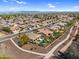 A bird's eye view shows homes featuring sparkling pools and scenic walking paths at 21141 E Stirrup St, Queen Creek, AZ 85142