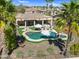 Relaxing backyard with a private pool, lush green lawn, an outdoor seating underneath a covered patio at 21141 E Stirrup St, Queen Creek, AZ 85142