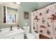 Charming bathroom featuring a cowboy themed shower curtain, rustic mirror, and updated sink at 21141 E Stirrup St, Queen Creek, AZ 85142