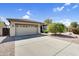 Charming home with a spacious driveway and a well-maintained desert-landscaped front yard at 21141 E Stirrup St, Queen Creek, AZ 85142