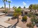Well-maintained single-story house with a low maintenance front yard and palm trees at 21141 E Stirrup St, Queen Creek, AZ 85142