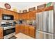 Kitchen features wooden cabinets, stainless steel appliances, and tiled backsplash at 21141 E Stirrup St, Queen Creek, AZ 85142
