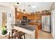 Kitchen featuring stainless steel appliances, breakfast bar seating, and wooden cabinets at 21141 E Stirrup St, Queen Creek, AZ 85142