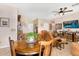 Open concept living and dining area with tile floors and a large TV at 21141 E Stirrup St, Queen Creek, AZ 85142