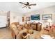 Relaxing living area with leather furniture, a wooden entertainment center, and a ceiling fan at 21141 E Stirrup St, Queen Creek, AZ 85142