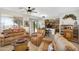 Open-concept living room featuring tile flooring, cozy leather furniture, and natural light at 21141 E Stirrup St, Queen Creek, AZ 85142