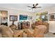 Cozy living room featuring comfortable leather furniture, a ceiling fan, and unique decor at 21141 E Stirrup St, Queen Creek, AZ 85142